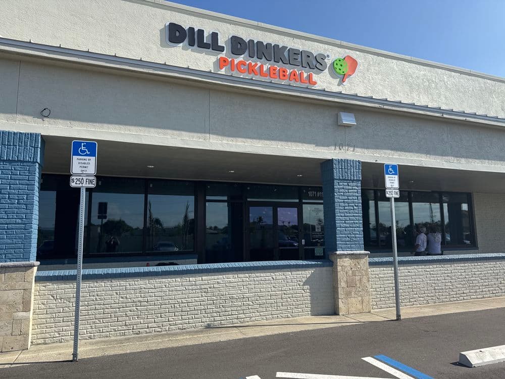 Dill Dinkers Pickleball facility exterior with parking and signage.
