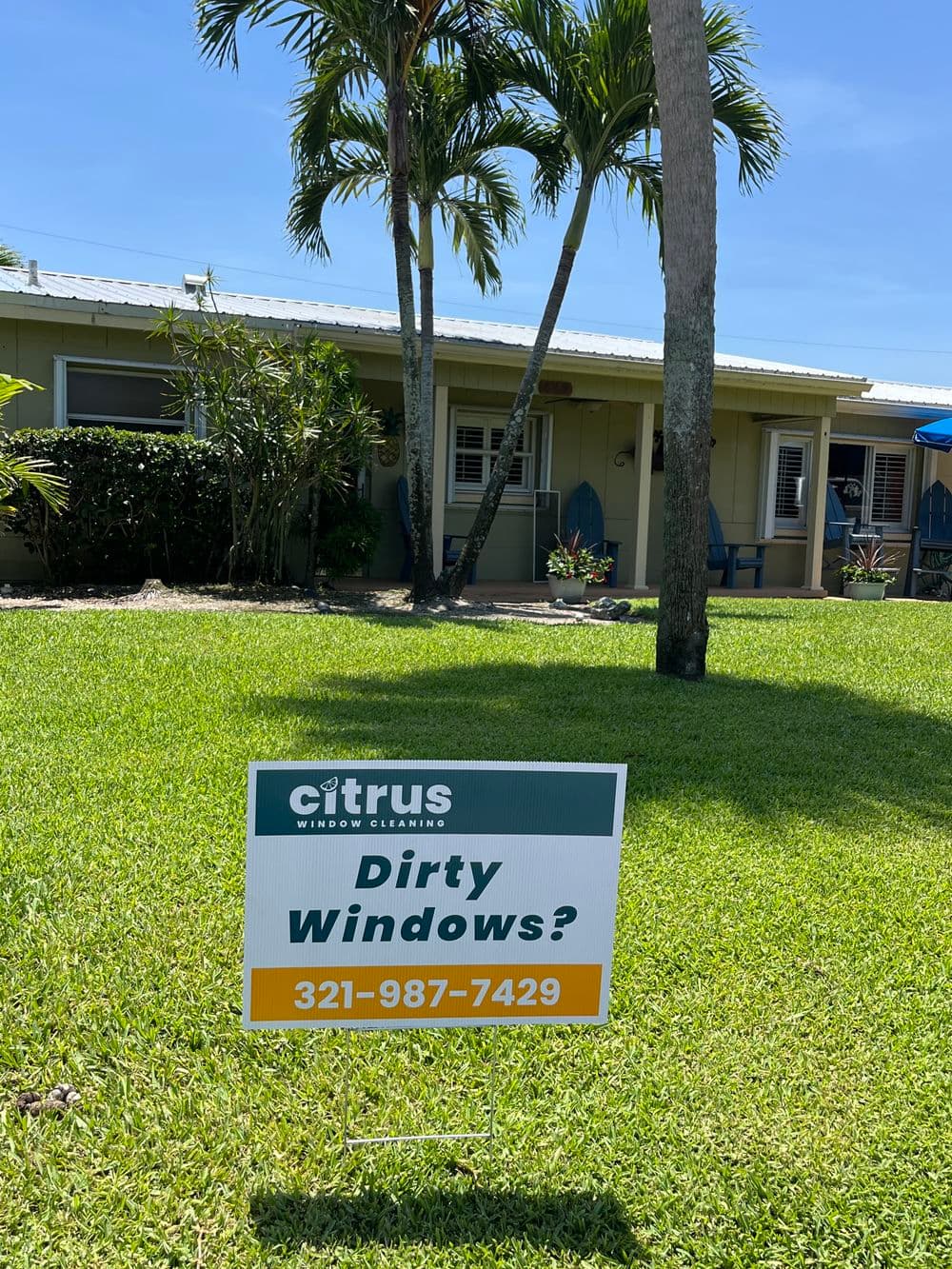 Citrus Window Cleaning sign in front of a house, promoting window cleaning services.